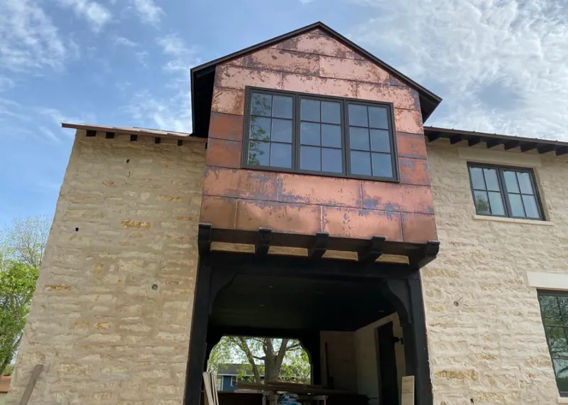 Copper metal panel facade on a stone building for Skylight Installation in Sonoma
